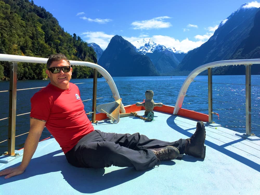 Andrew Wells enjoying some rare sunshine in Milford Sound
